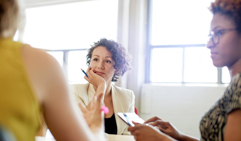 Three women in an office meeting